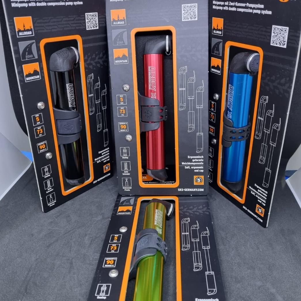 A Bunch Of Different Colored Bicycle Pumps In Their Packaging — Trinity Cycle Works In Cairns City, QLD