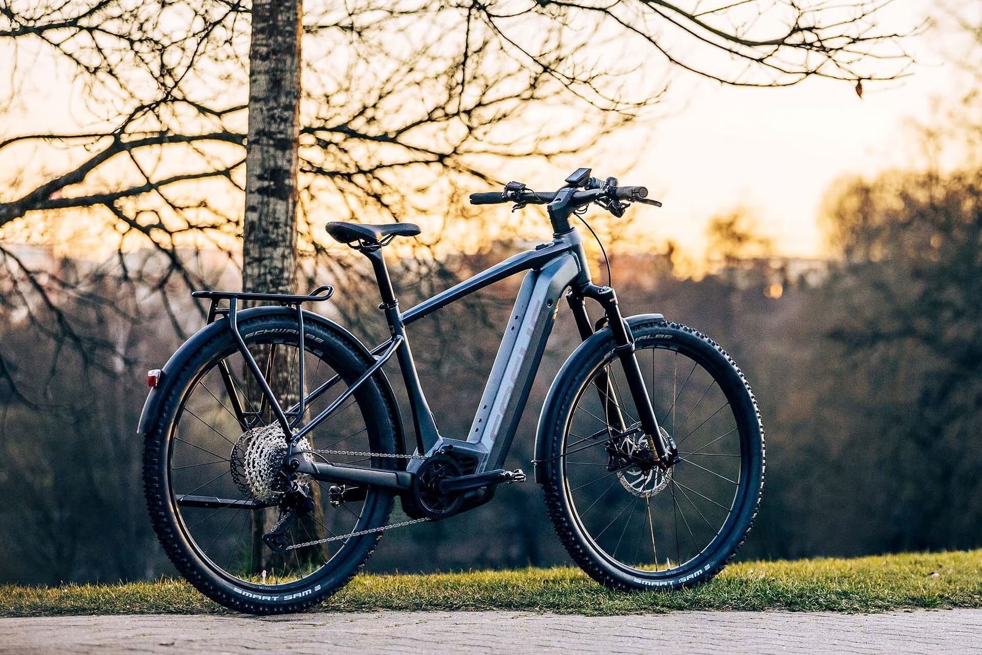 An Electric Bicycle Is Parked On The Side Of A Road Next To A Tree — Trinity Cycle Works In Cairns City, QLD