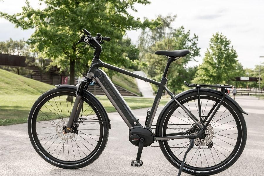 An Electric Bicycle Is Parked On The Side Of The Road In A Park — Trinity Cycle Works In Cairns City, QLD