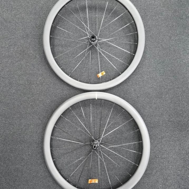 Two White Bicycle Wheels Are Stacked On Top Of Each Other — Trinity Cycle Works In Cairns City, QLD