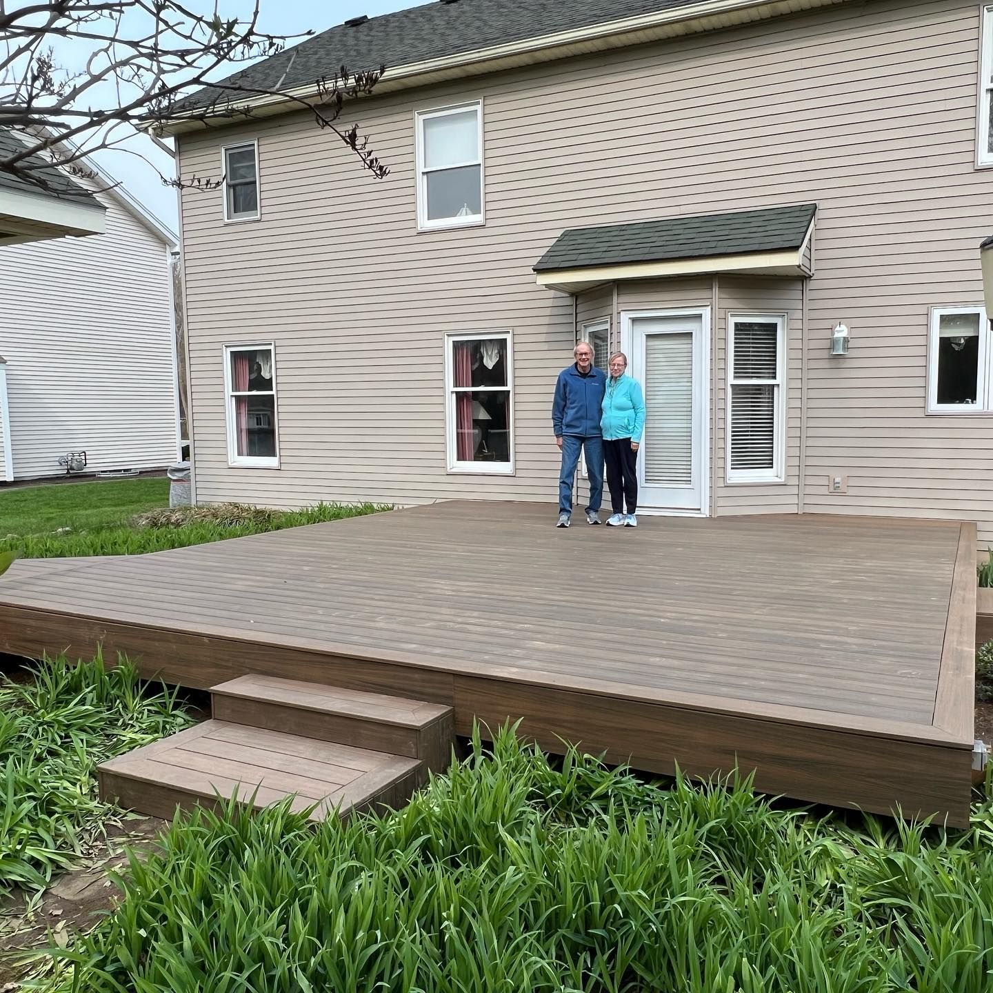 Happy Couple Standing on Their New Deck