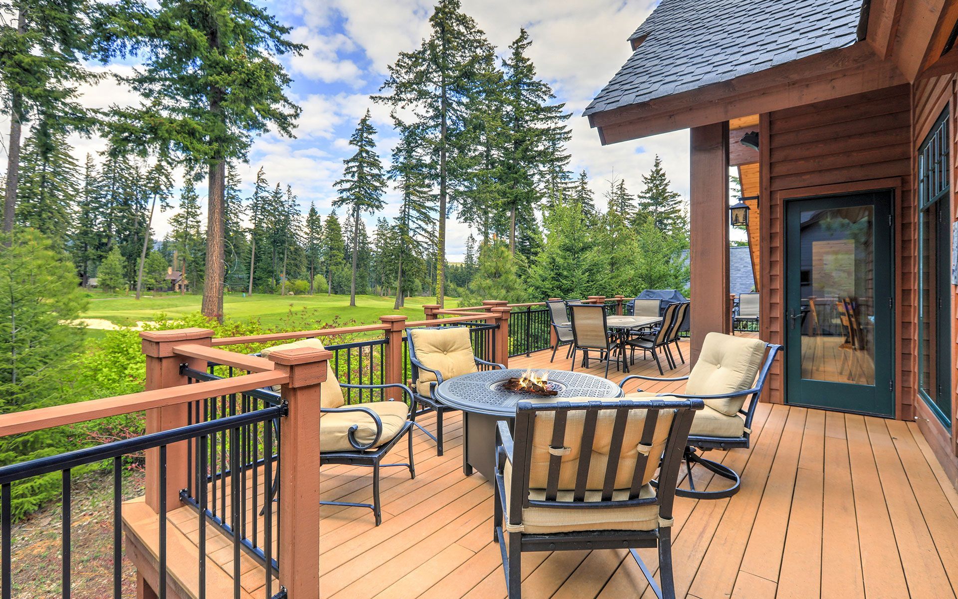 There is a large deck with a table and chairs on it.