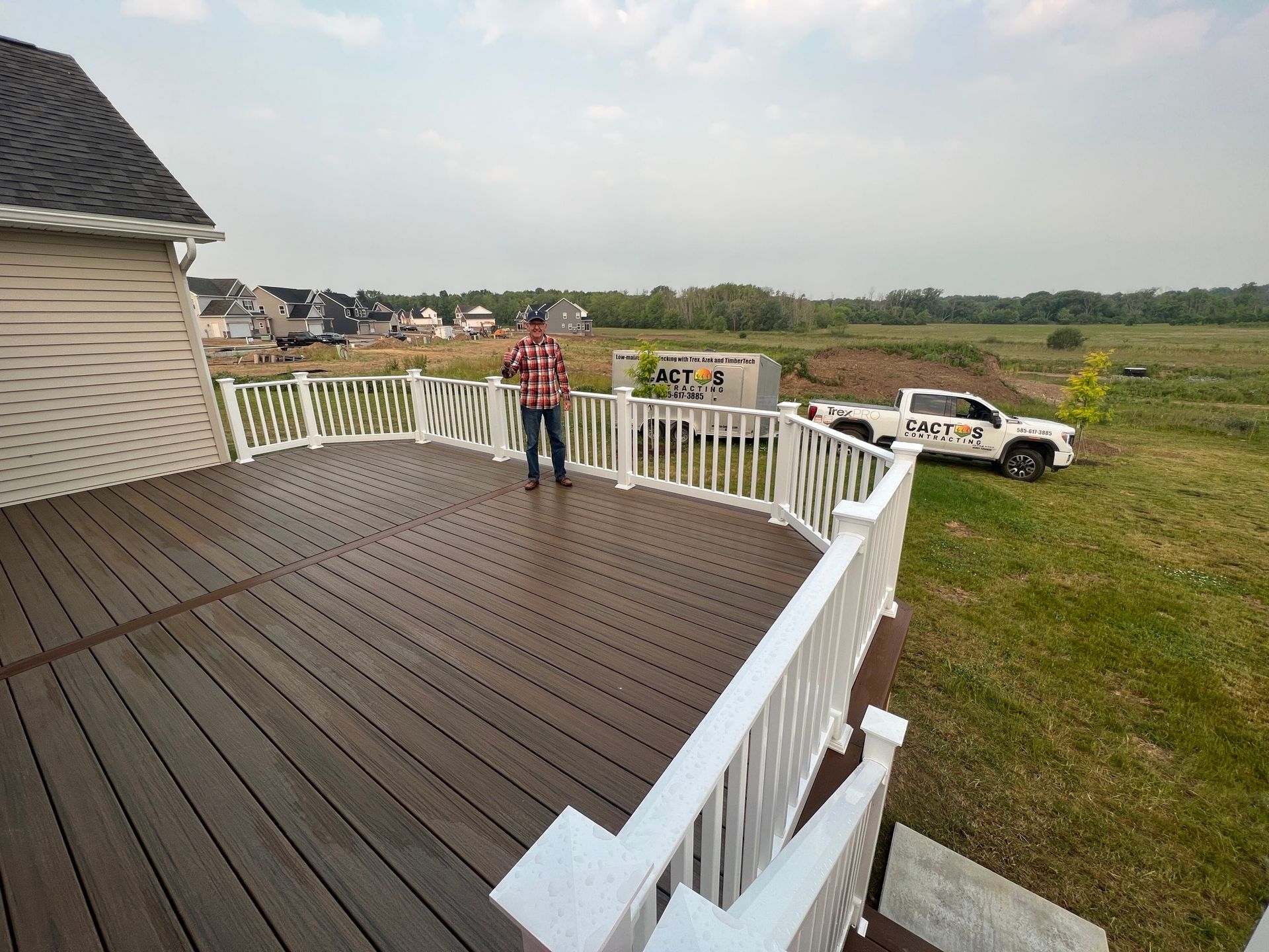 A wooden deck with stairs next to a house.