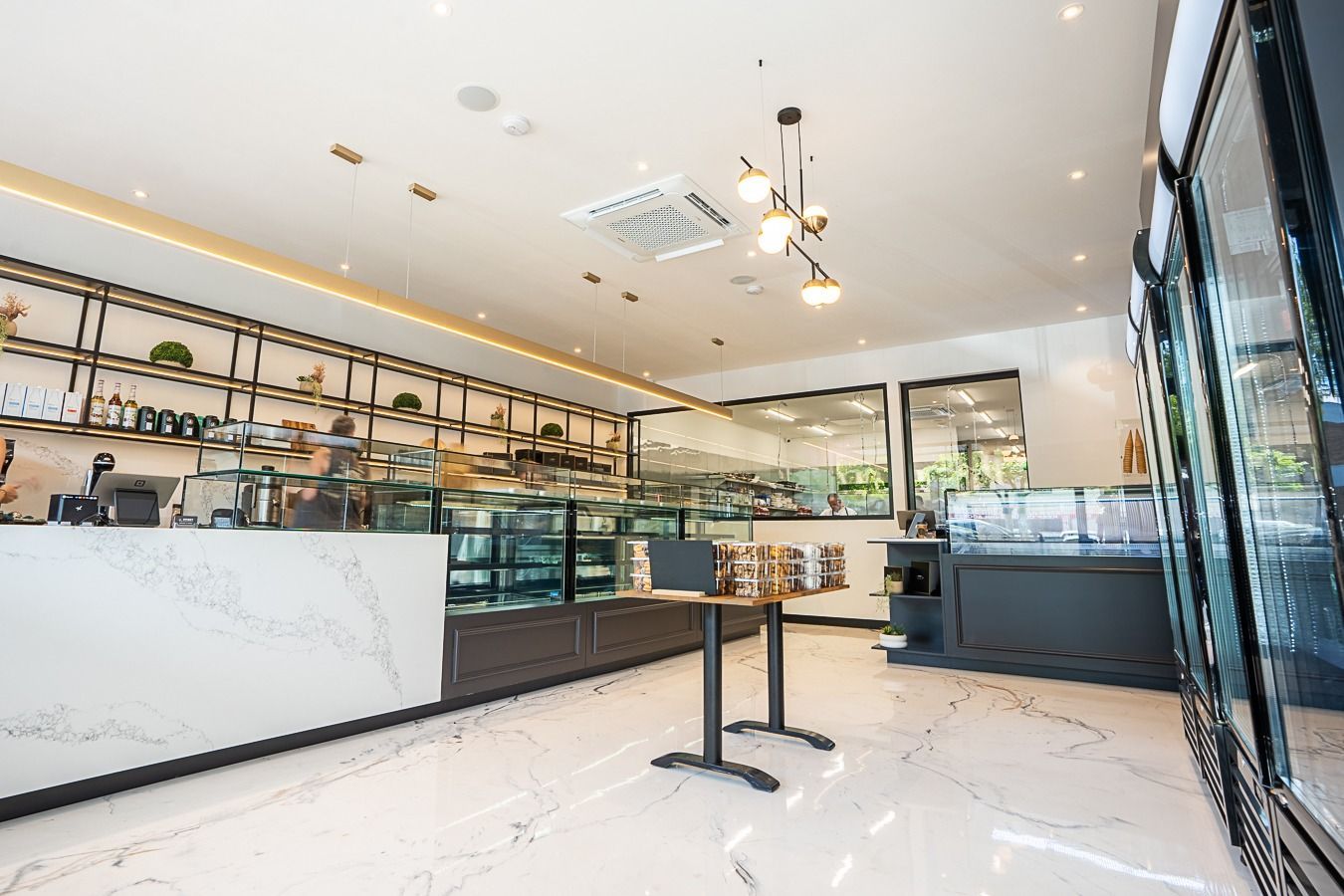 Interior of a Modern Bakery, White Marble Counters, Display Cases