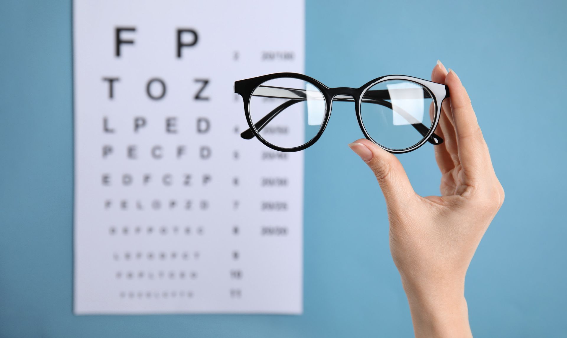 Holding Eyeglass And Eye Chart — Evesham, NJ — Tristate Eyecare