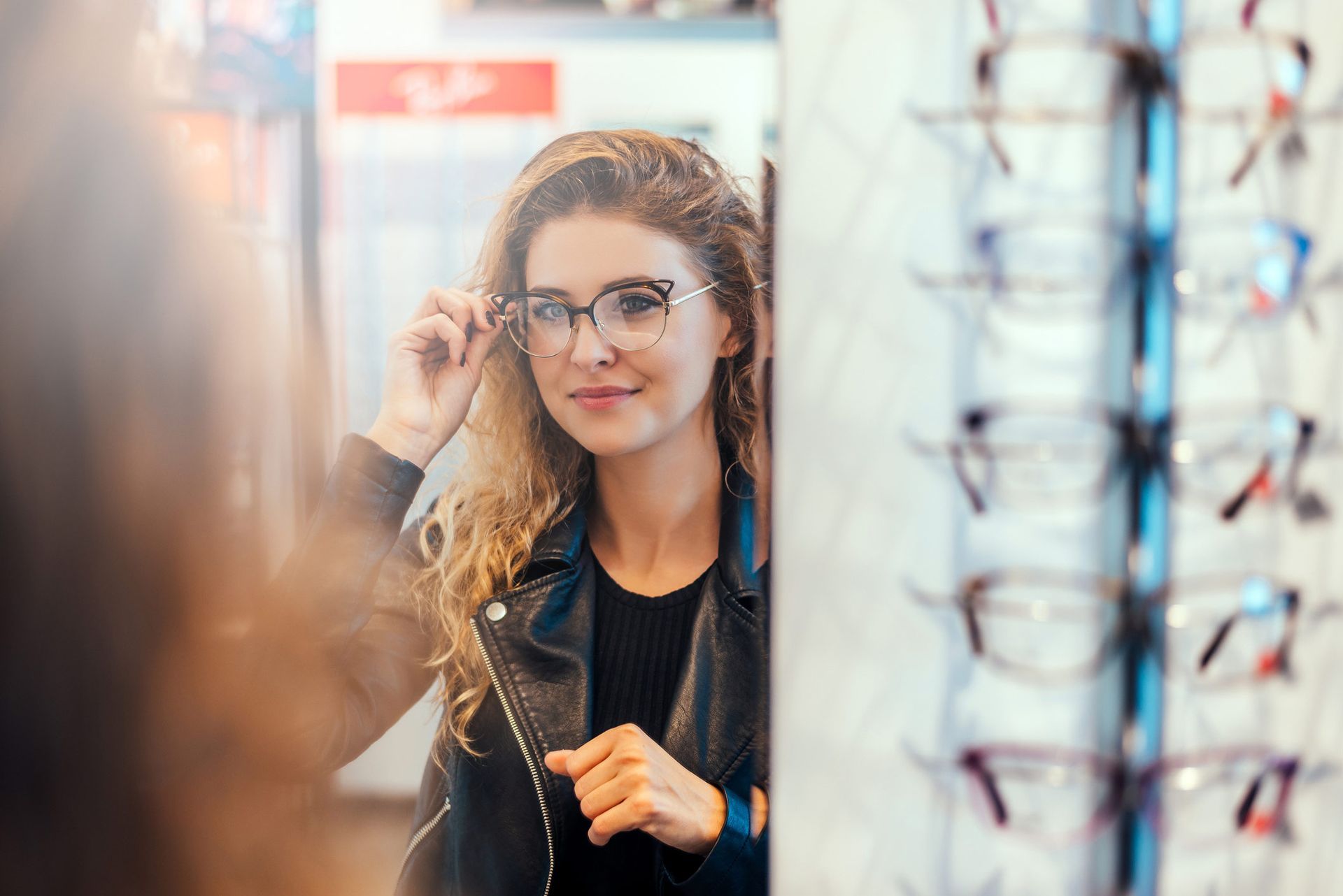 Woman Trying On Eyeglasses On Mirror — Evesham, NJ — Tristate Eyecare