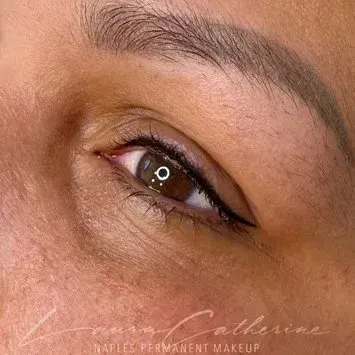 Close-up of an eye with permanent eyeliner.