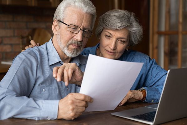 elderly couple looking over paperwork