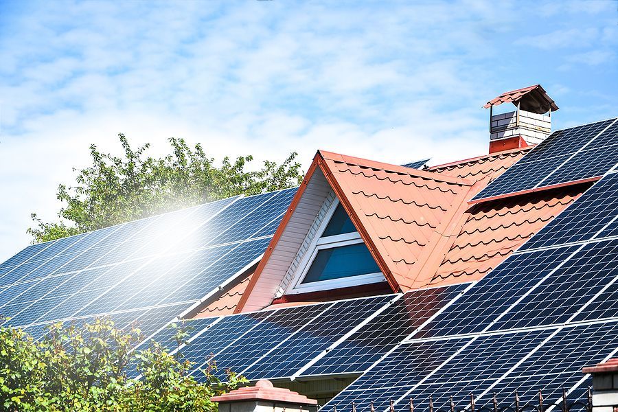 A row of solar panels on the roof of a house