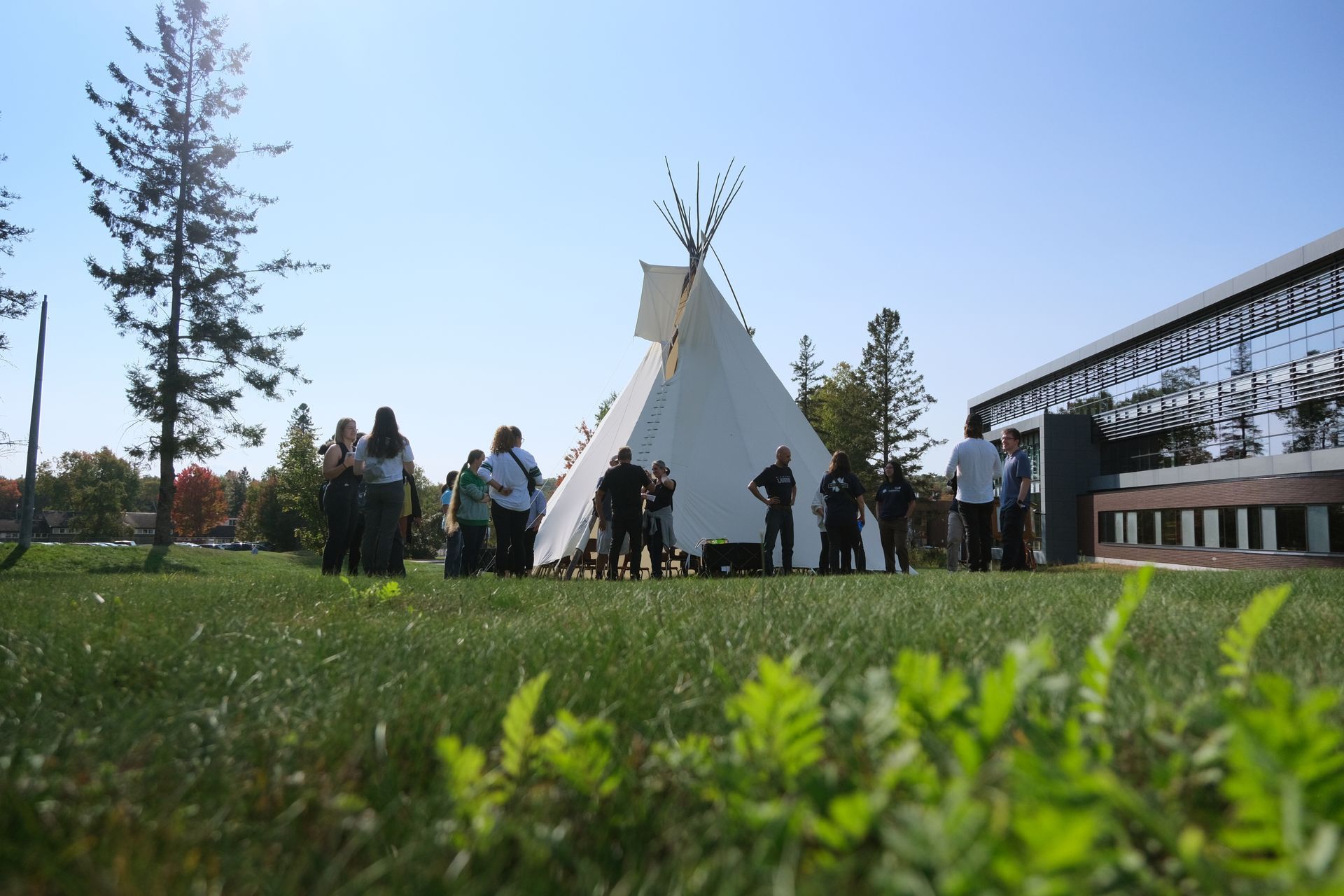 Students outside by the tipi