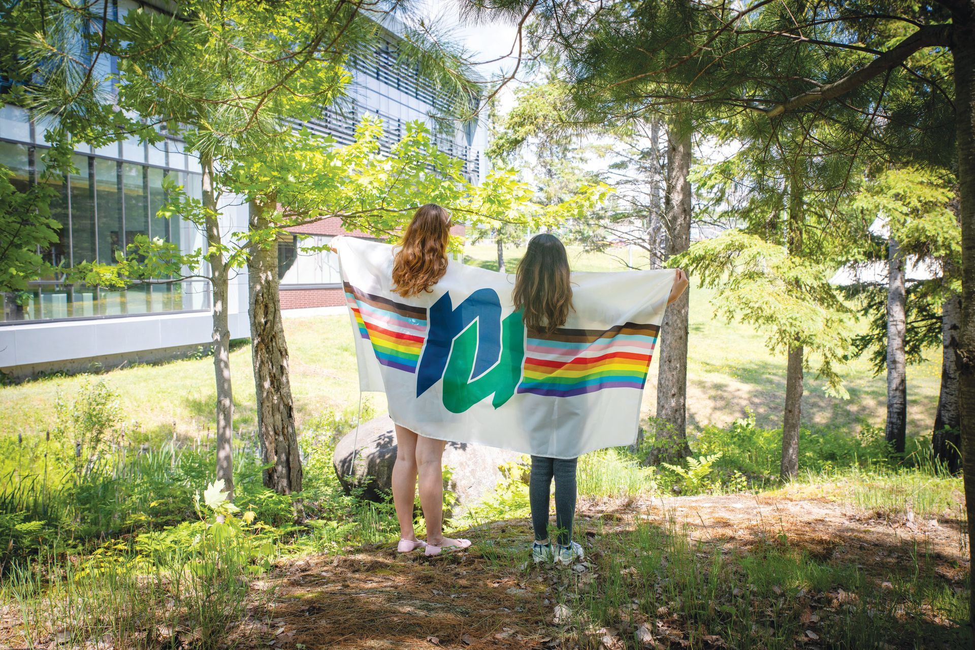 Students holding the NU pride flag