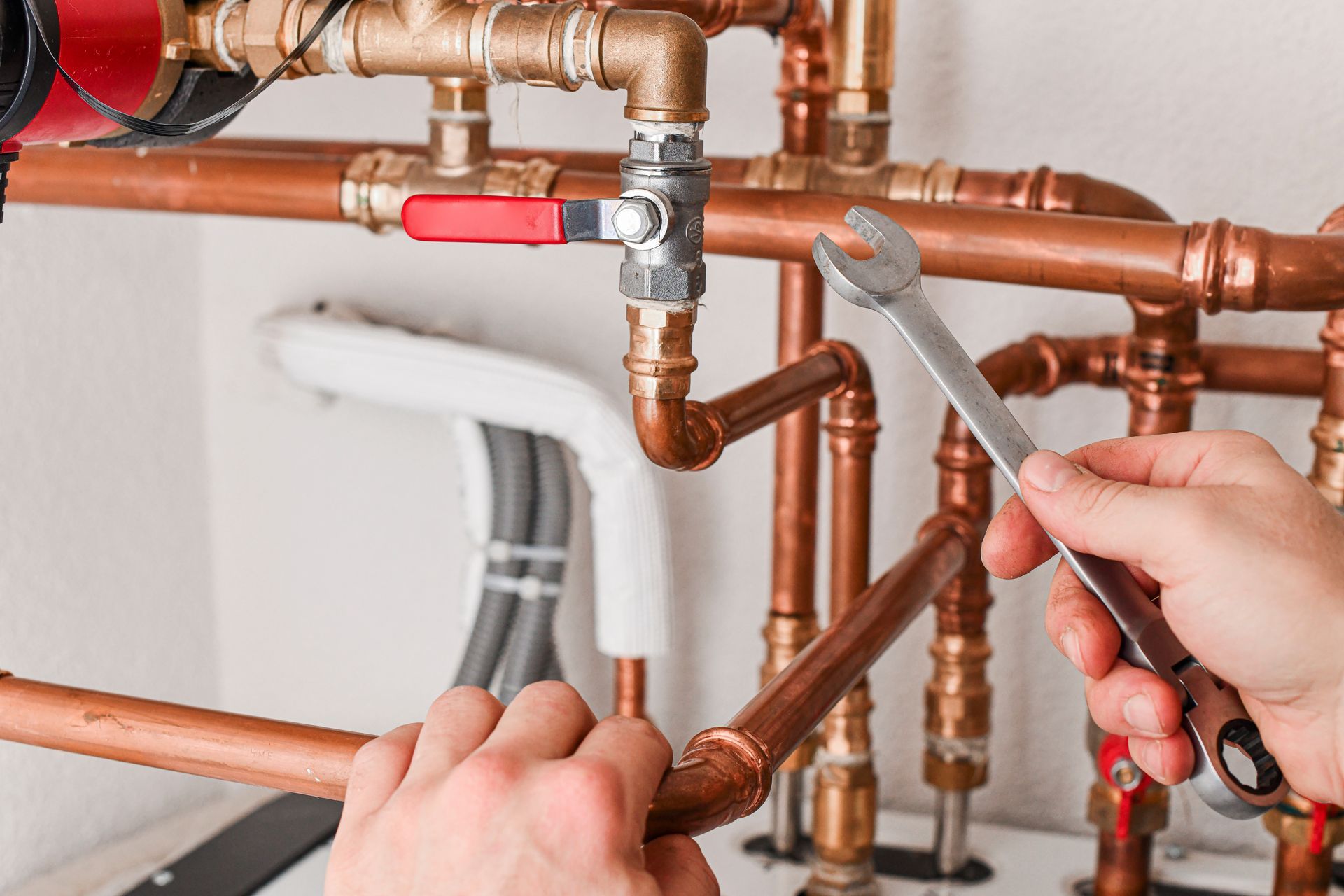 Fixing a water valve by an emergency heating contractor.