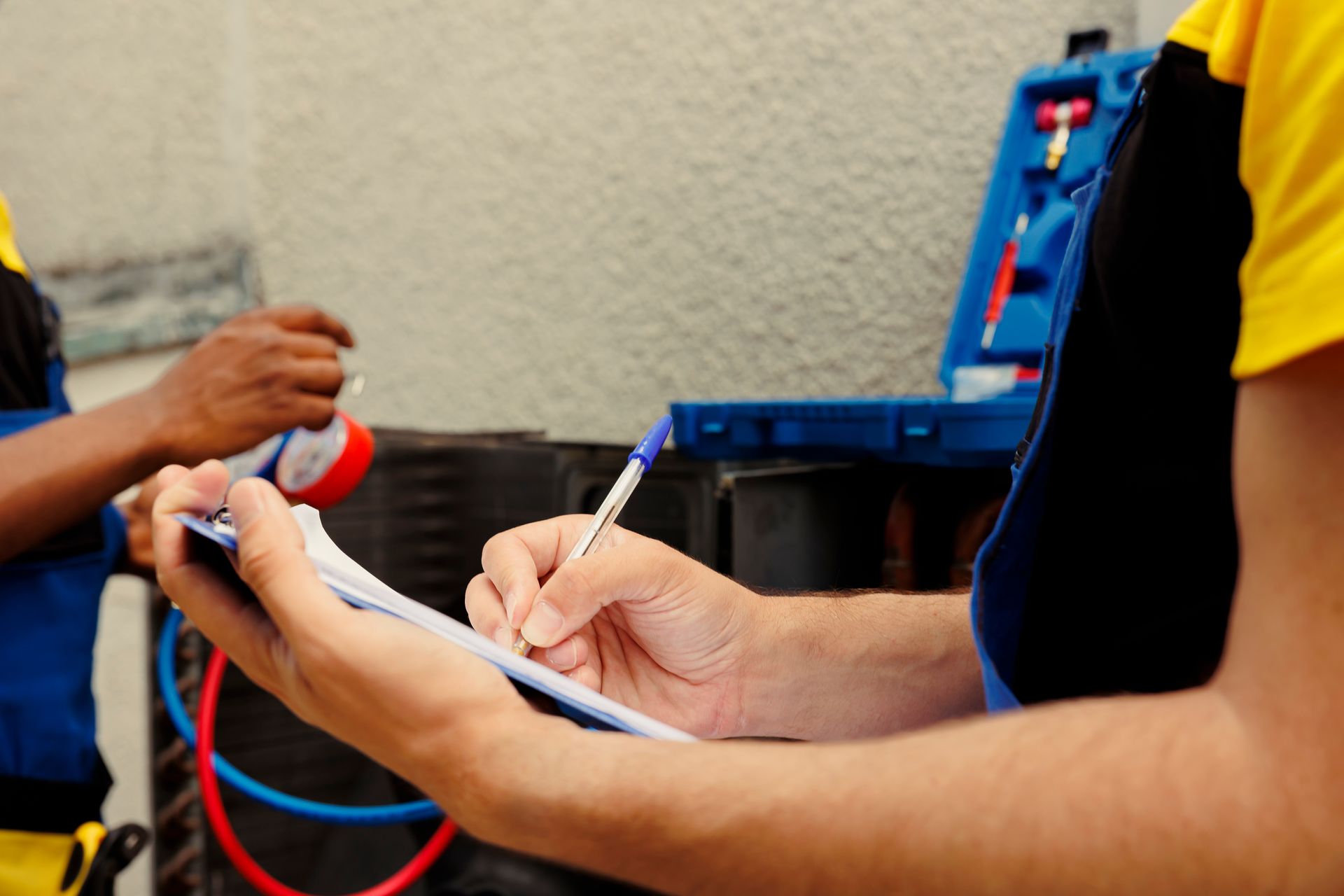 Expert HVAC service contractor diagnosing an outdoor AC unit with pressure gauges and a checklist.