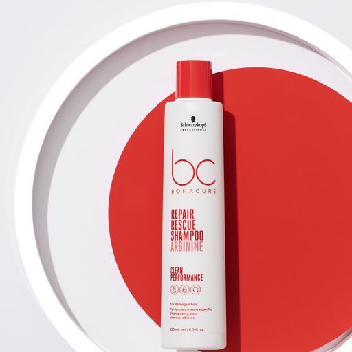 A bottle of Schwarzkopf Professional Bonacure Repair Rescue against a red background