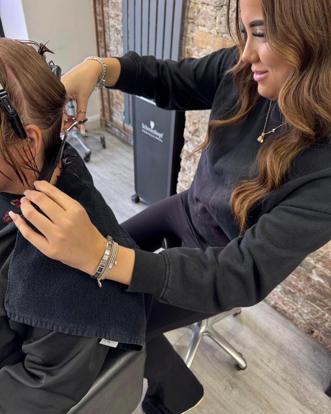 Brooke performing a precision haircut during stylist training at THE TRUTH IN COLOUR™