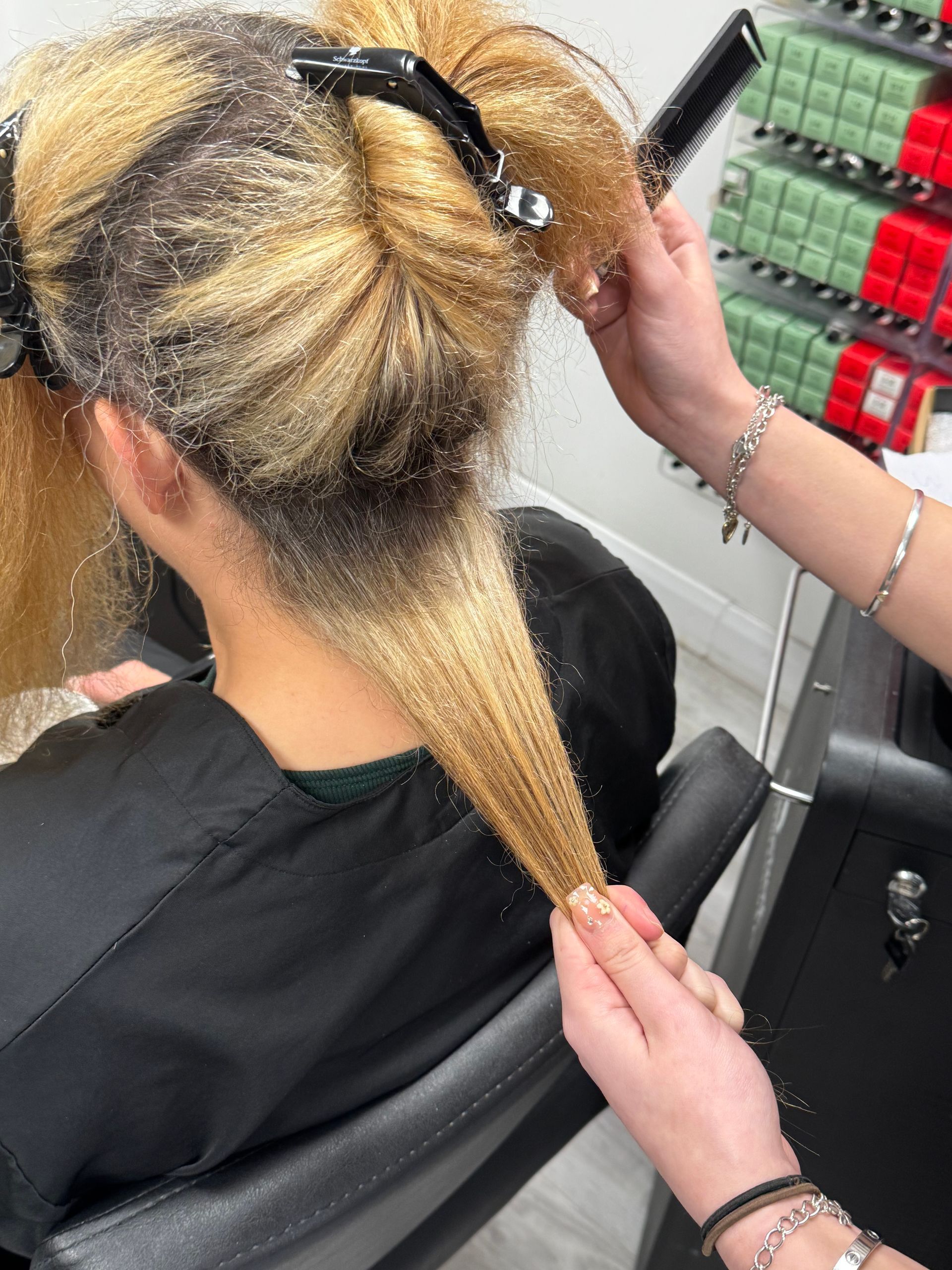 Hair colour history being assessed with visible regrowth and uneven blonde tones