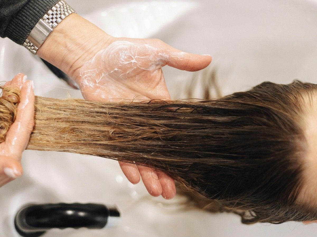 Hair condition assessment during a salon appointment at THE TRUTH IN COLOUR™