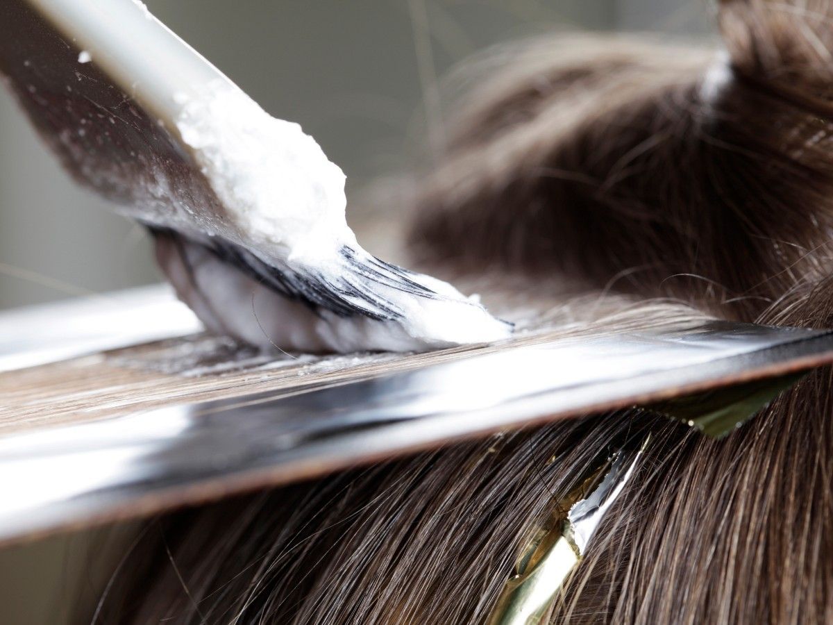 Hair colour being carefully applied during a professional salon appointment