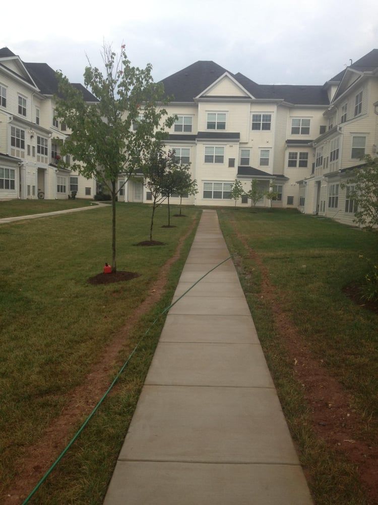 A large white building with a walkway leading to it
