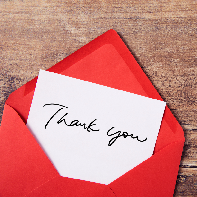 A red envelope with a thank you card inside