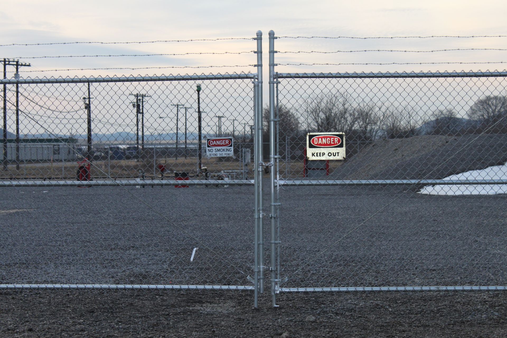 A chain link fence with a danger sign on it