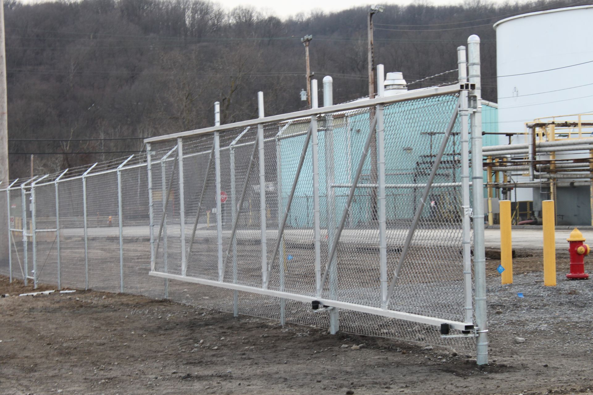 A chain link fence with a fire hydrant in front of it
