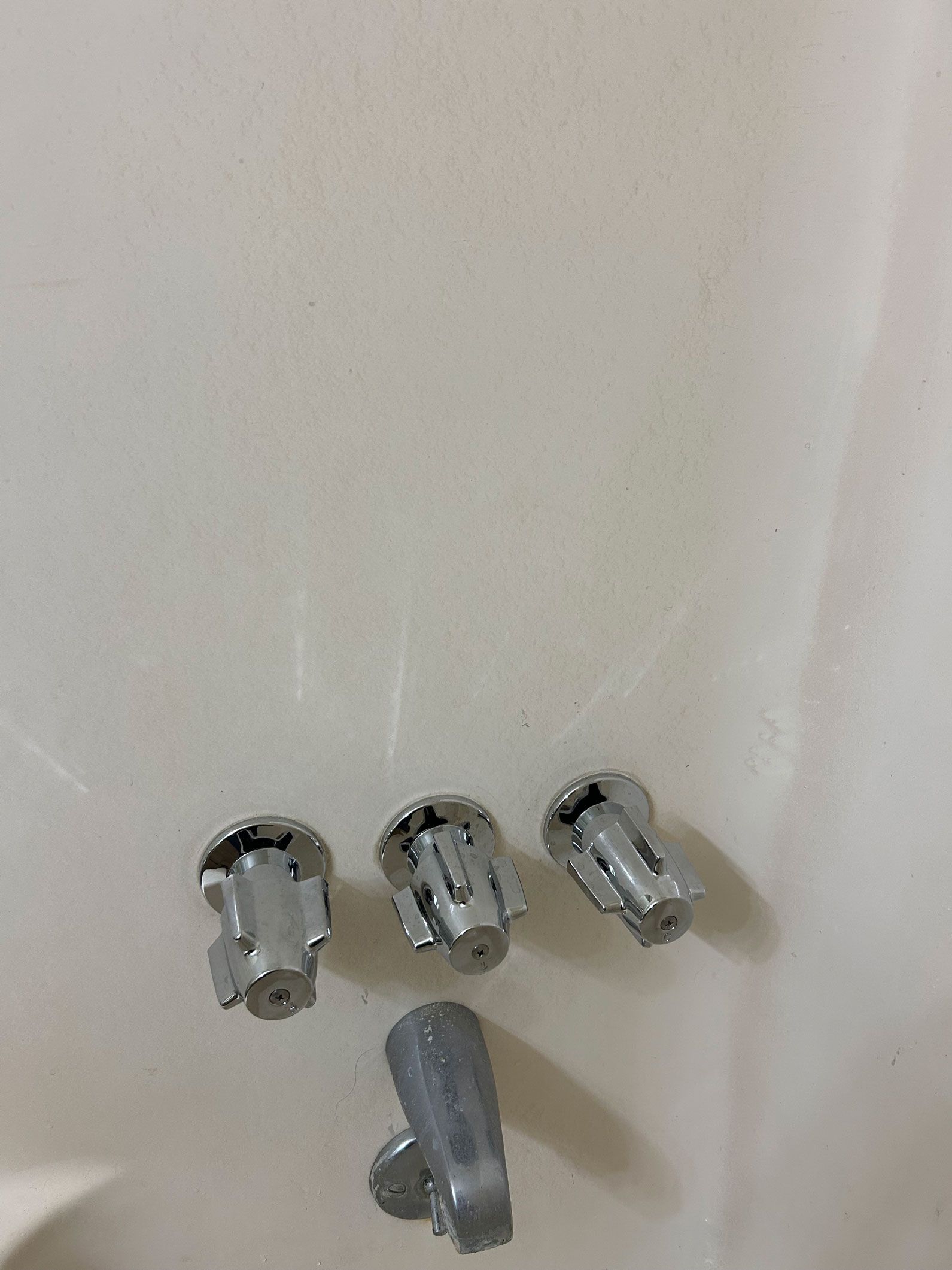 Four gray plastic fasteners on a white surface.