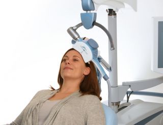 woman using a transcranial  magnetic stimulation device