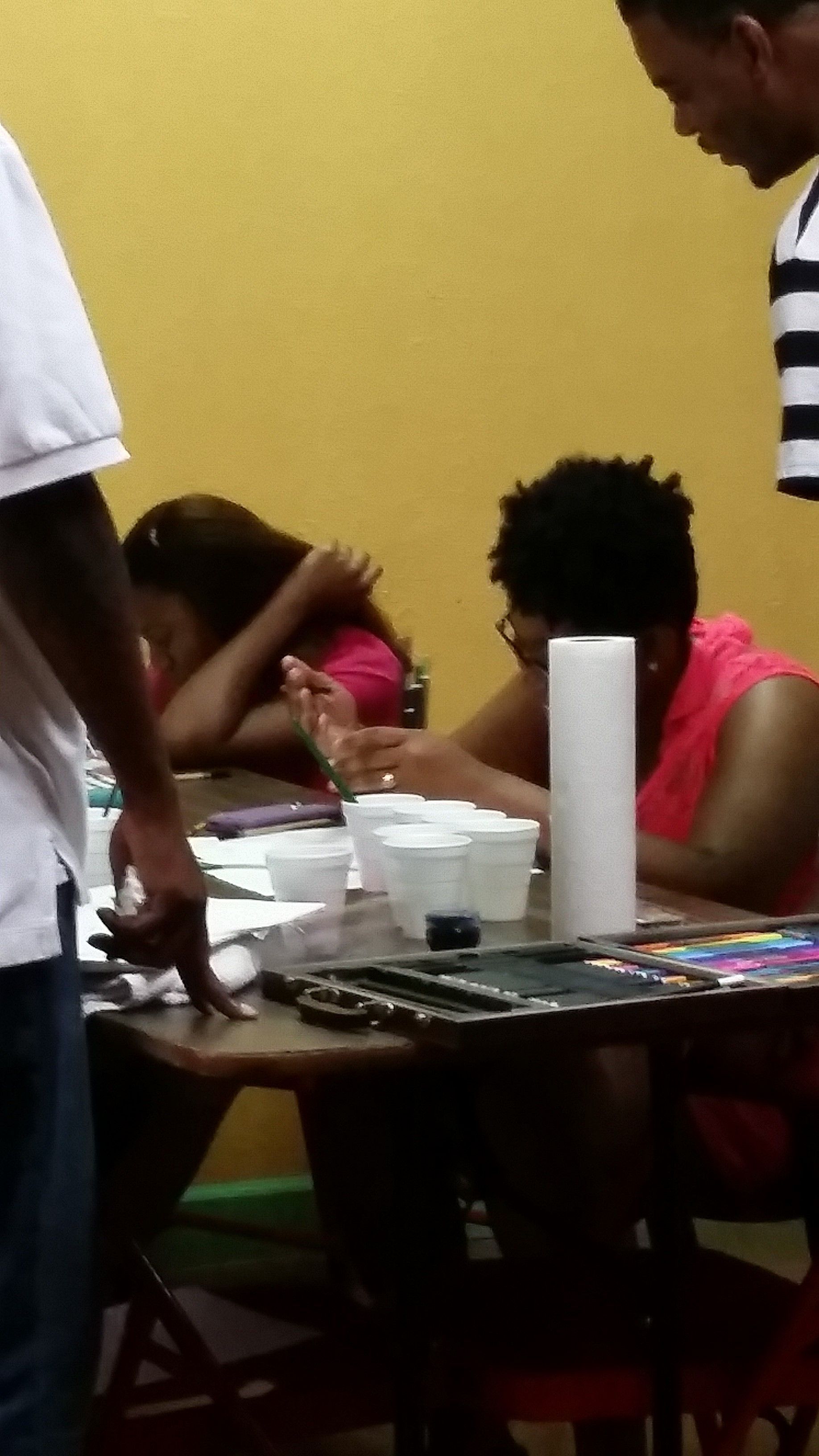 A Group of People Sitting at a Table With a Paper Towel on It