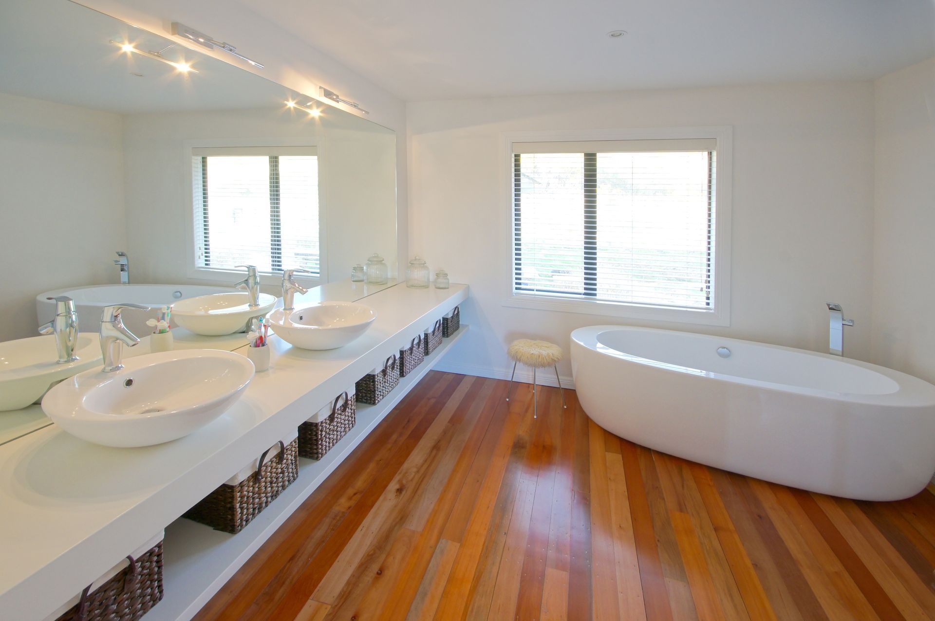 A bathroom with two sinks and a bathtub. Statement Homes Christchurch