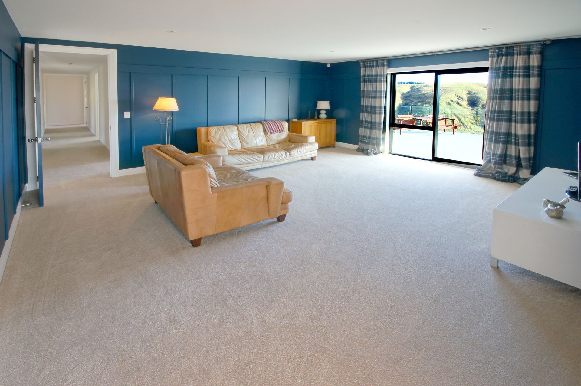 A living room with a couch and a table Statement Homes Christchurch