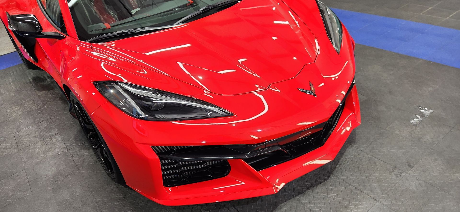 Bright red sports car angled from the front.