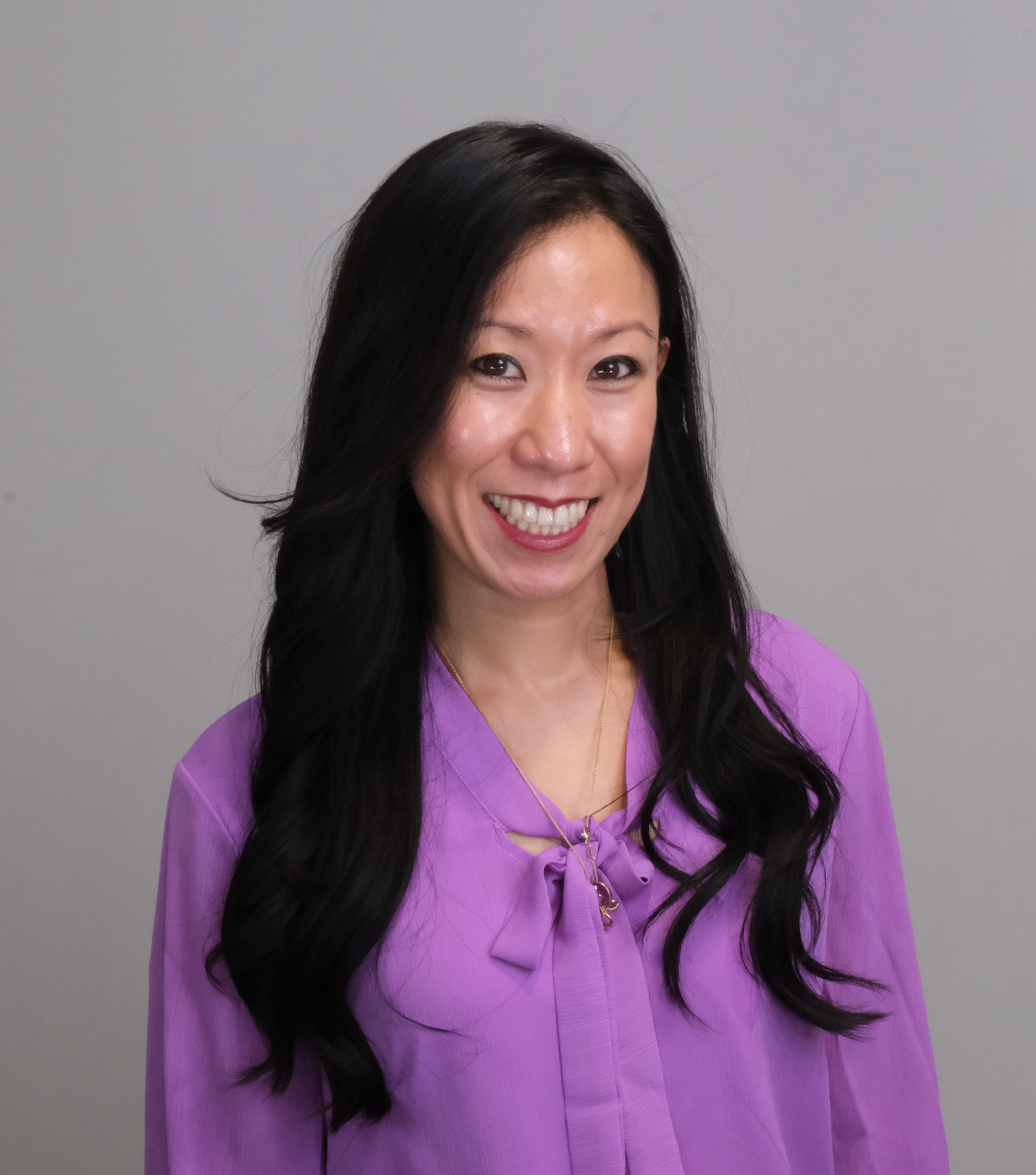 A man with a beard is wearing a blue suit and a bow tie.