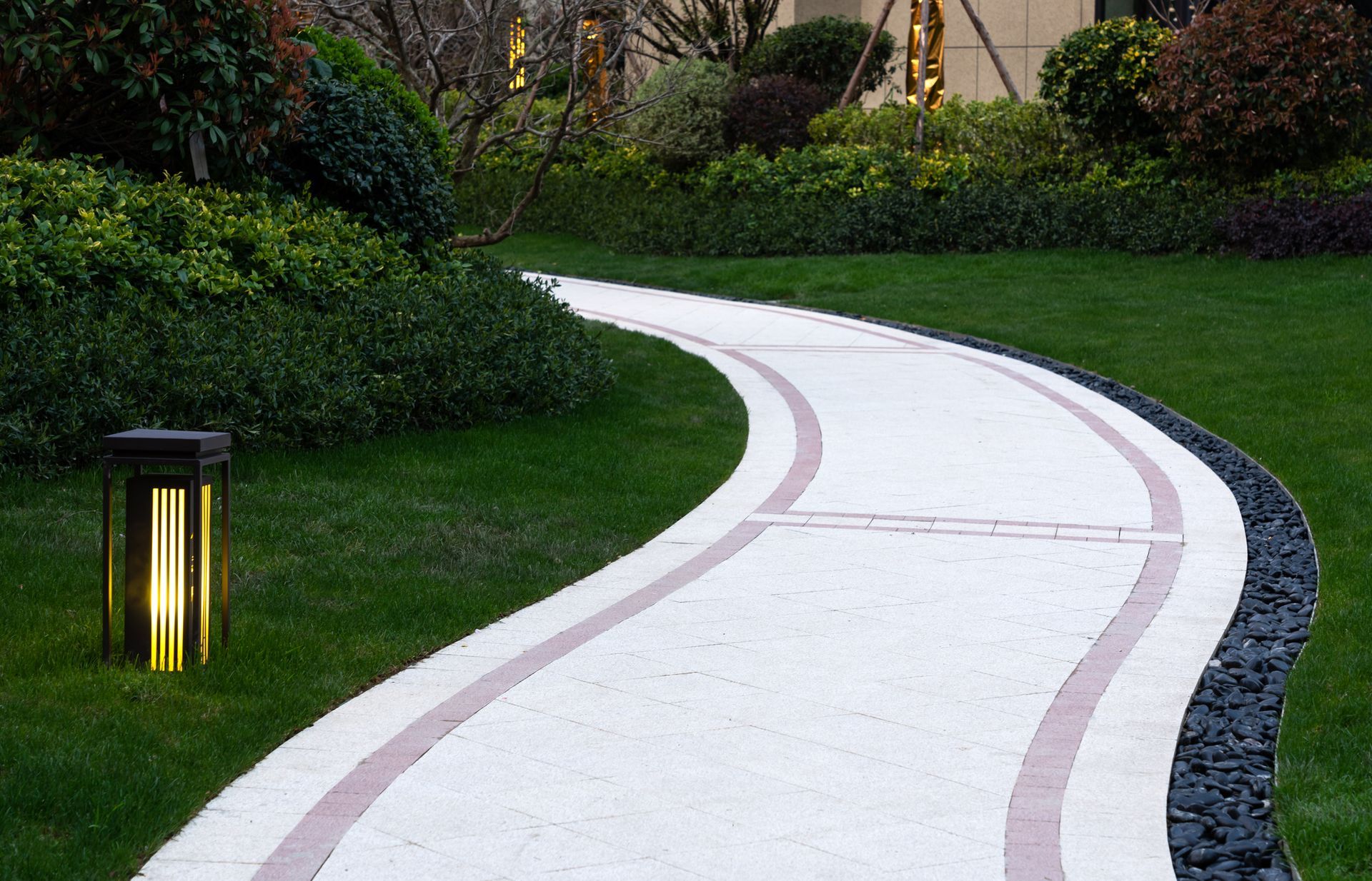 There is a lantern on the side of the path.