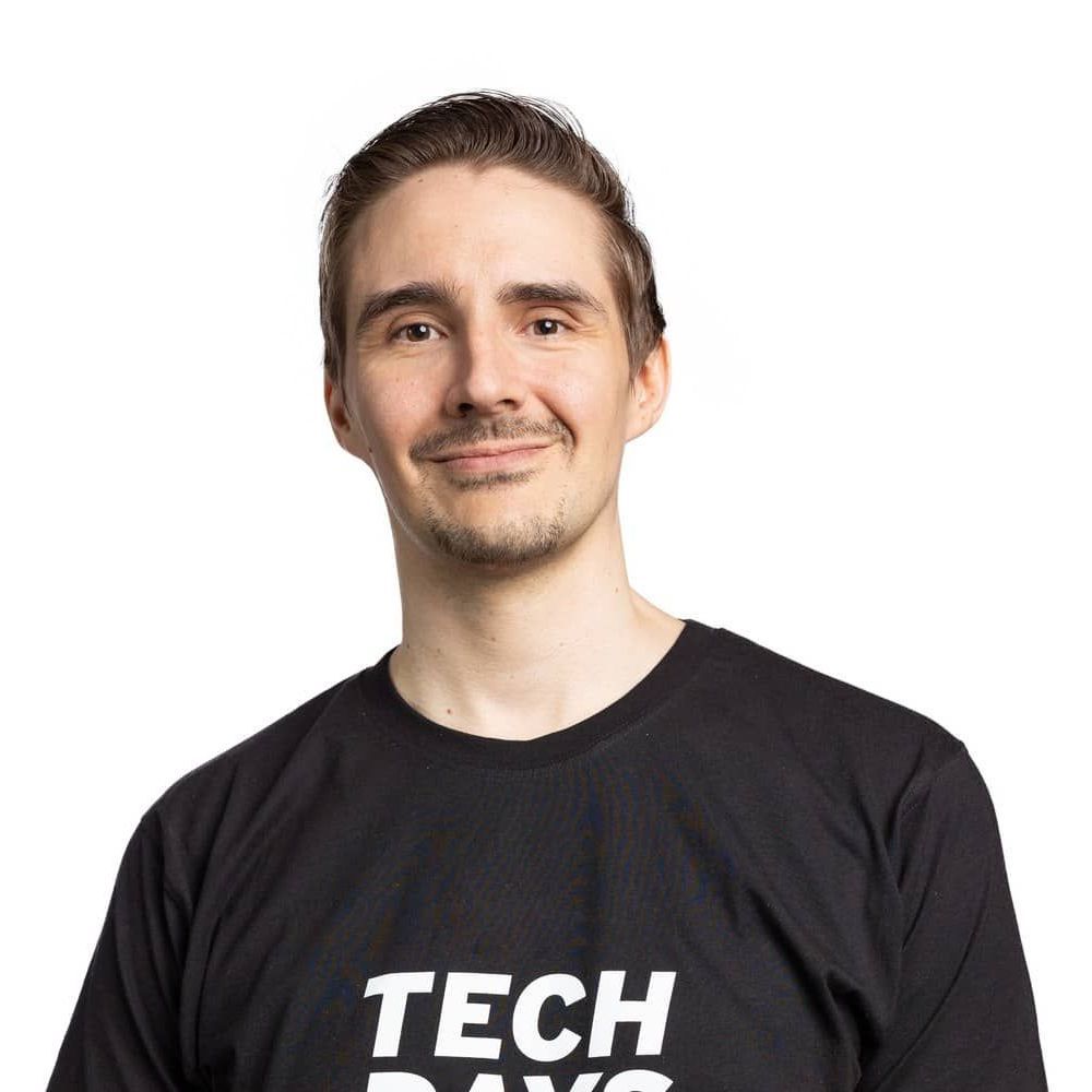 A man wearing a black t-shirt that says tech days