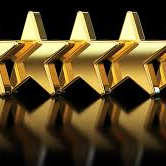 Five gold stars in a row, with dark reflections on a shiny black surface.