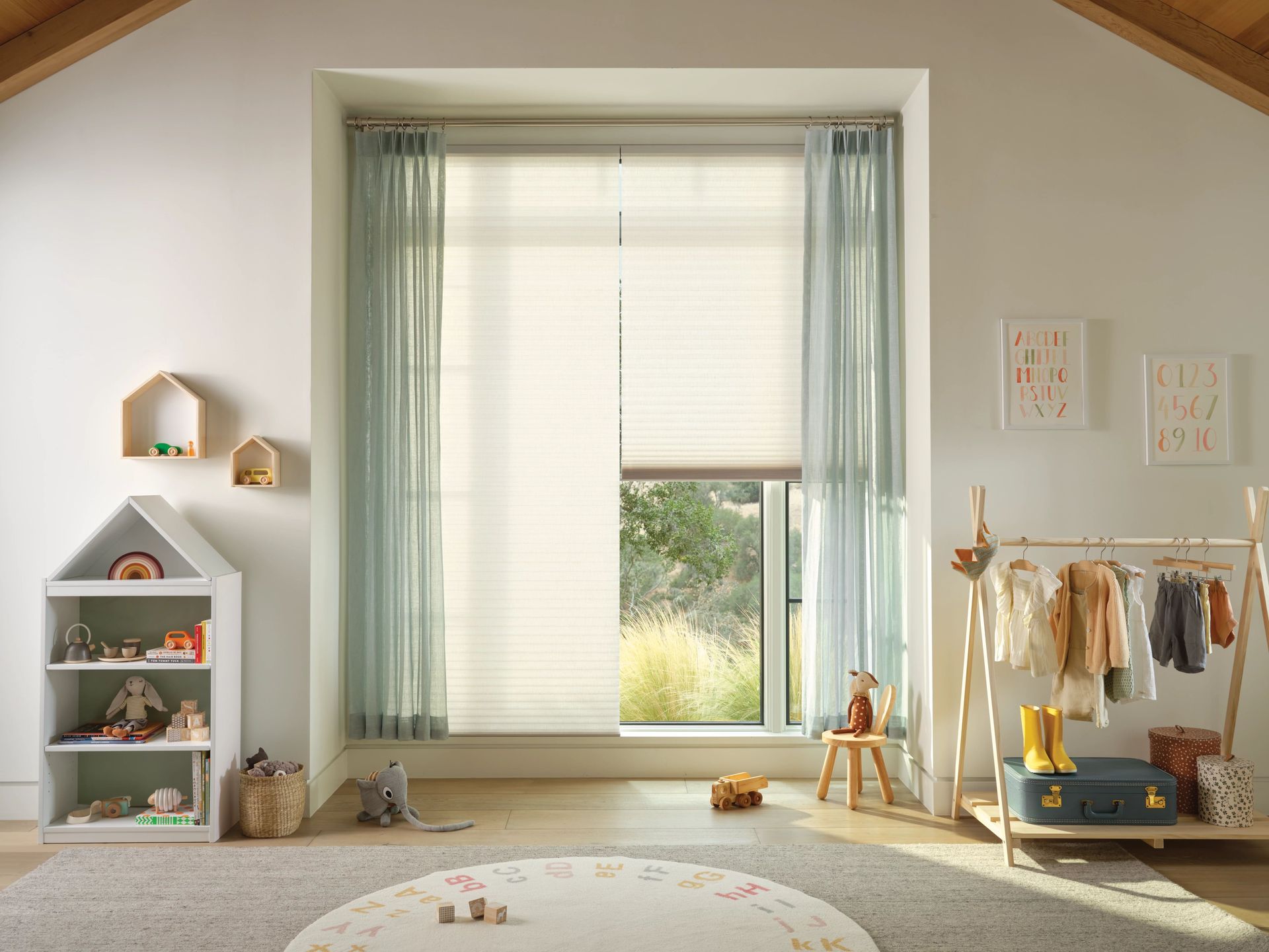 a child's room featuring a play area, toys, and blinds on the window