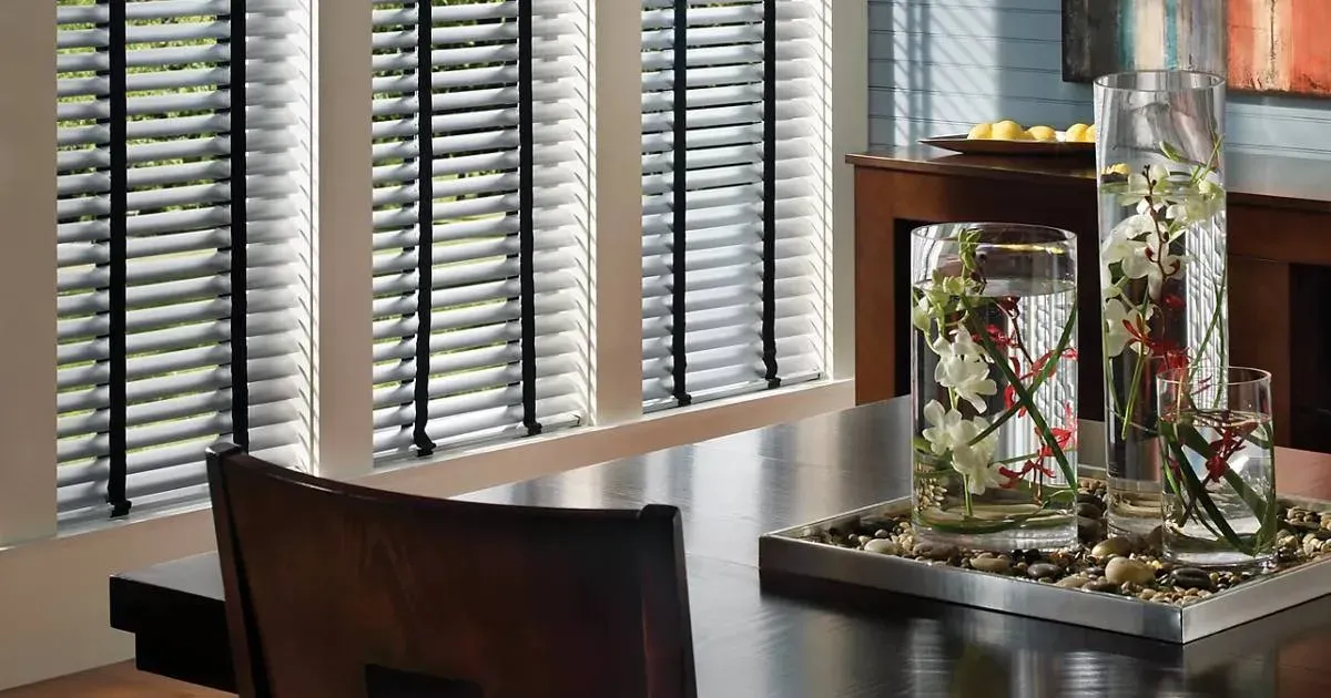 A dining room table with a vase of flowers on it.