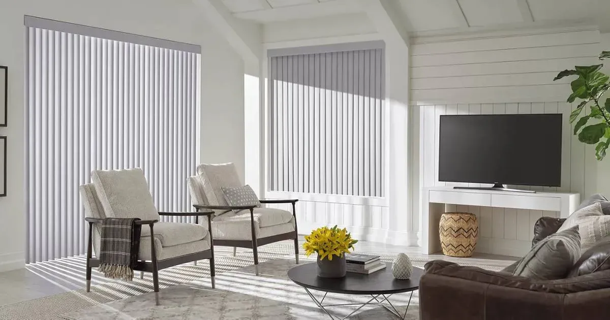 A living room with a couch , chairs , and a television.
