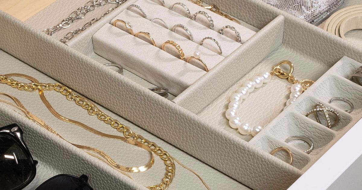 A jewelry tray filled with necklaces , rings , and bracelets.