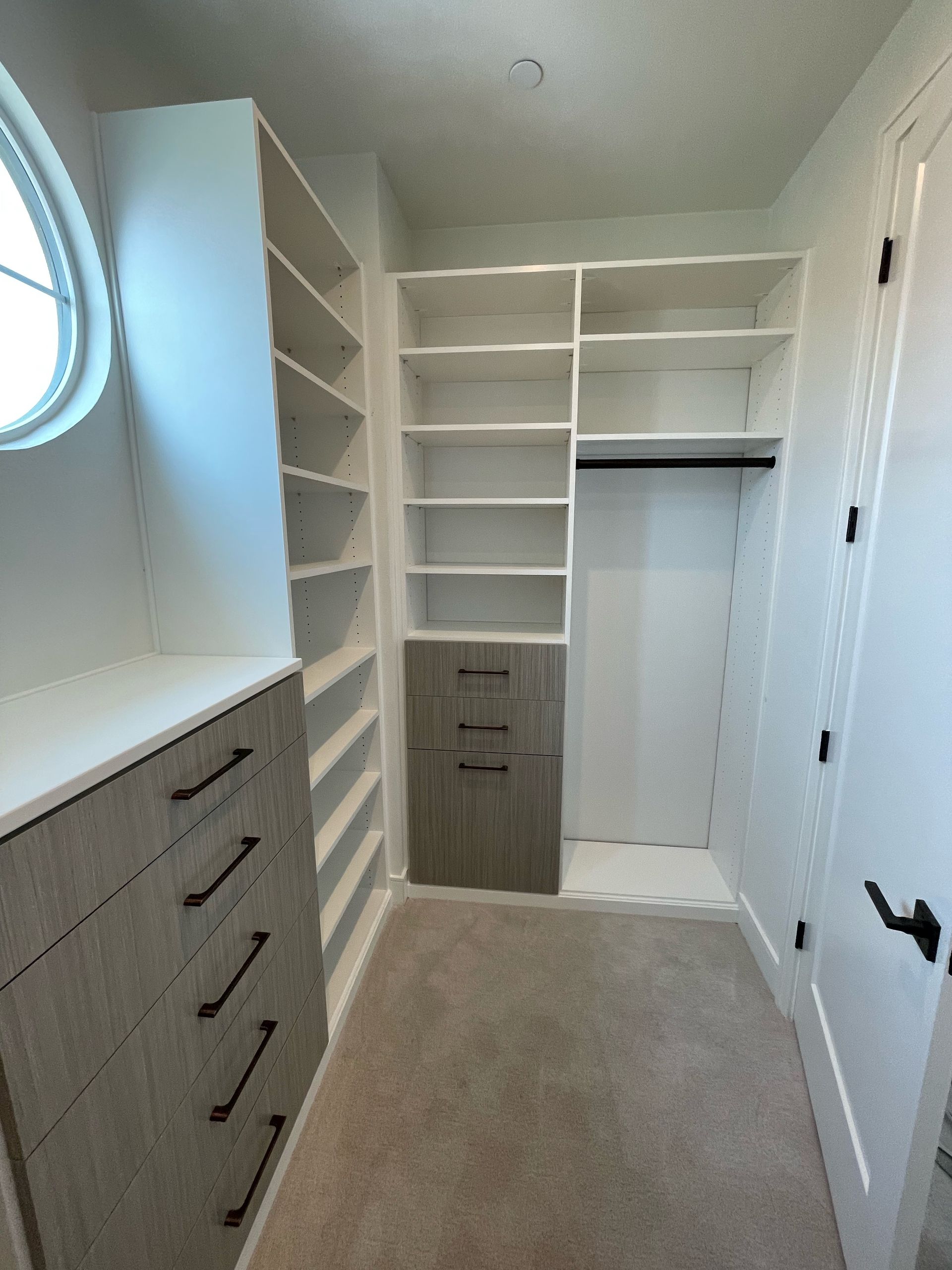 a walk in closet system with ample shelves and drawers