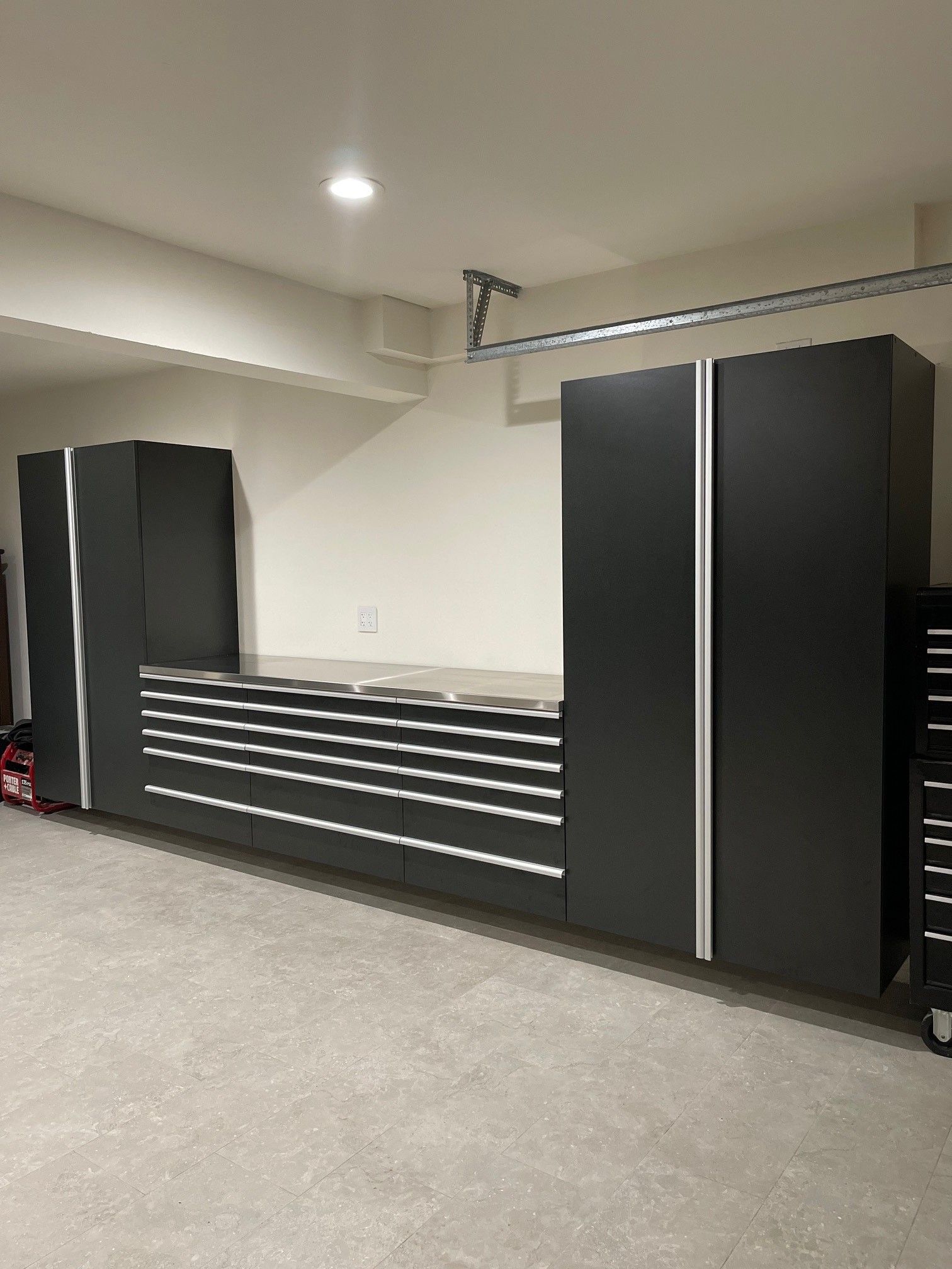 a garage filled with lots of basalt color cabinets and drawers .