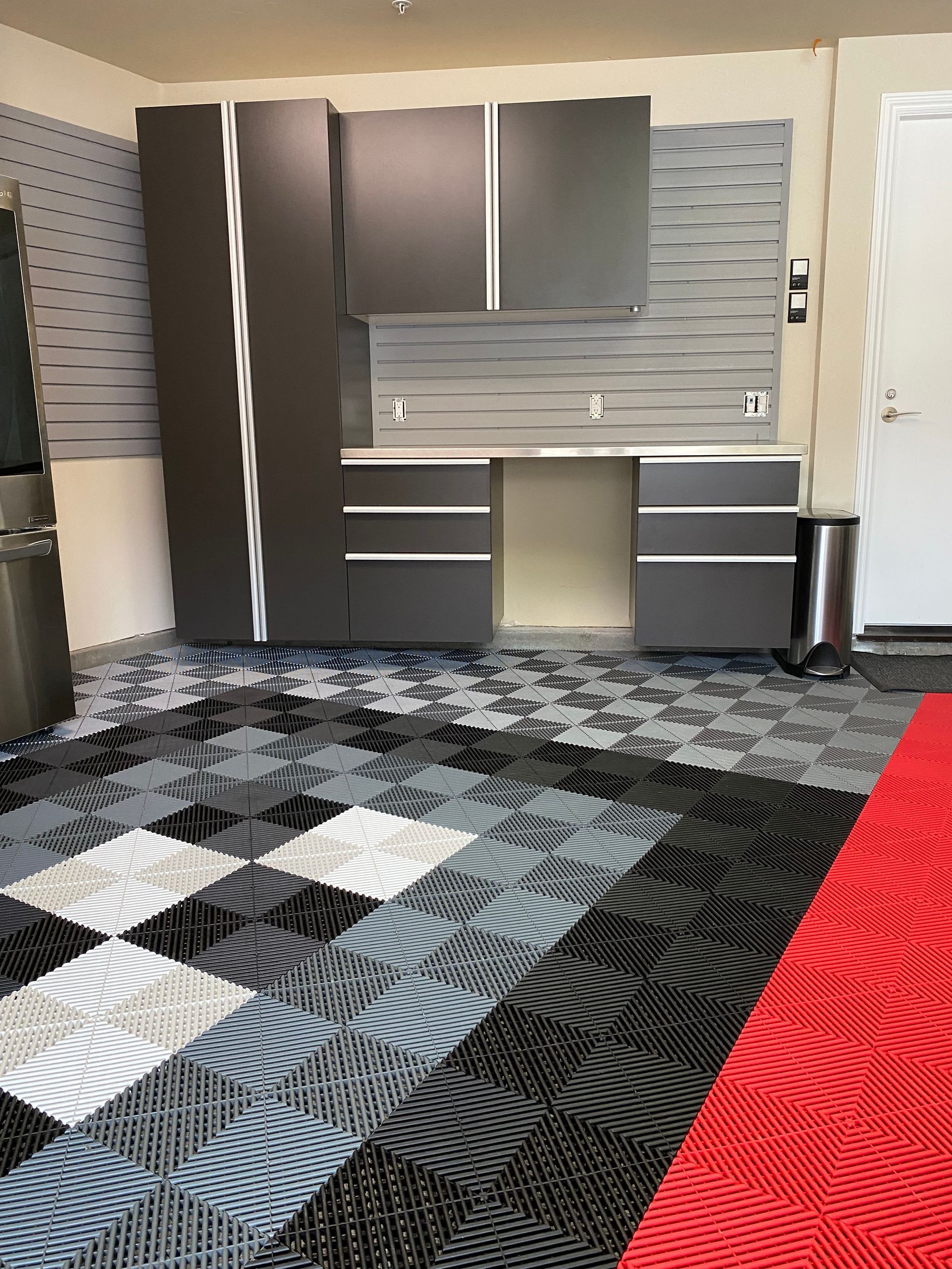a garage with custom cabinetry and Swisstrax flooring