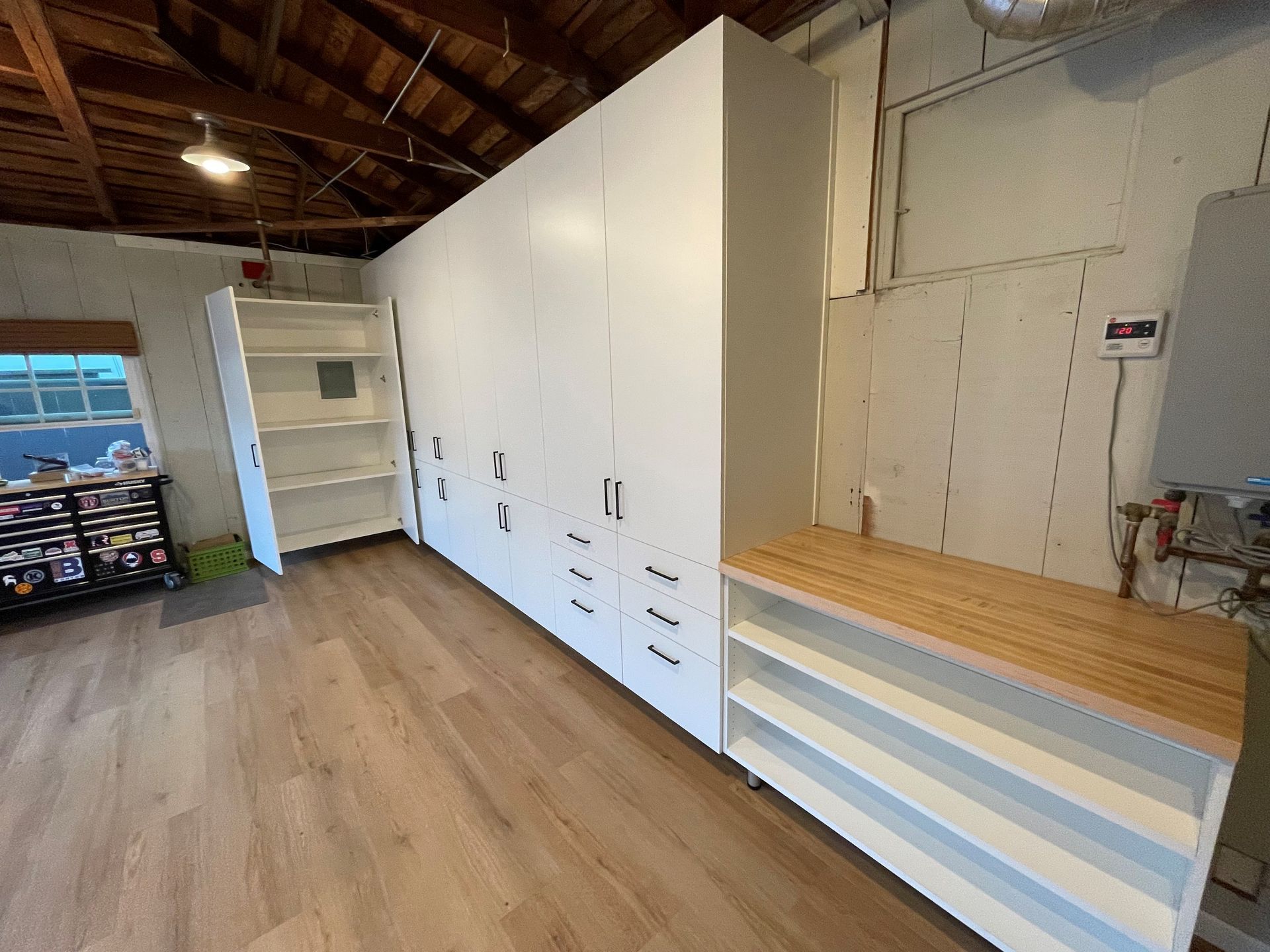 tall custom garage cabinets and integrated bench with shelving