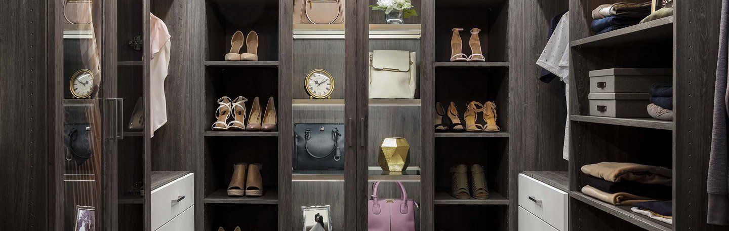 A spacious walk-in closet with neatly organized shelves, hanging clothes, and shoe racks.