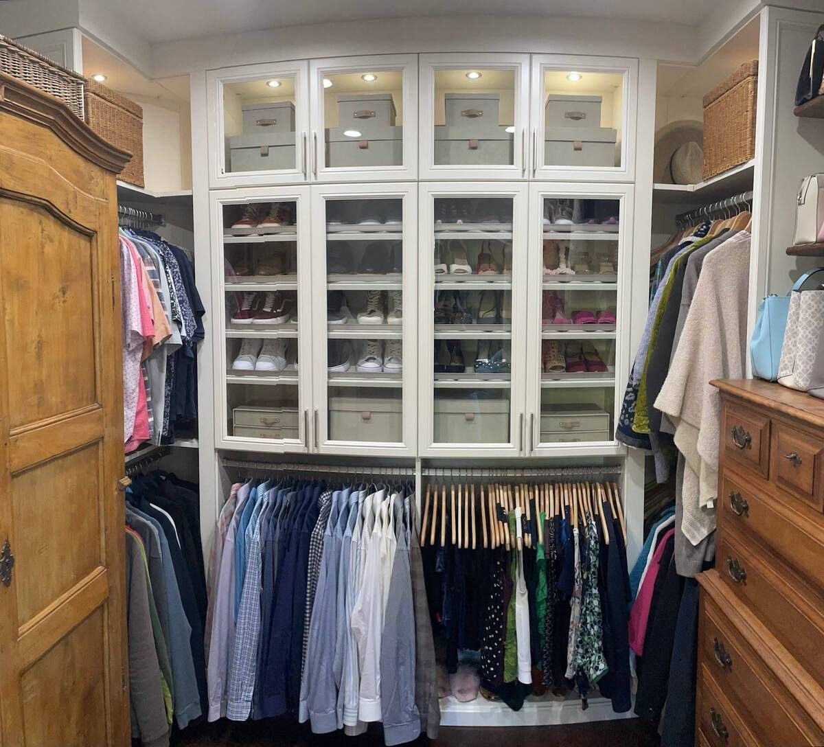 a walk in closet filled with lots of clothes and shoes .
