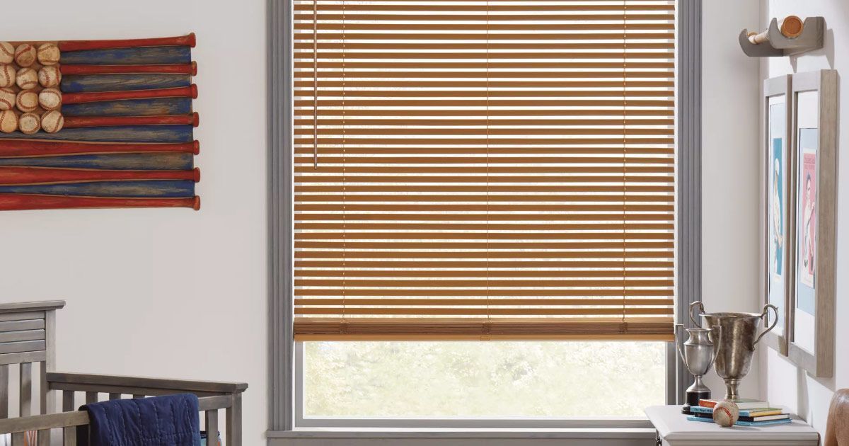 a wooden cabinet with clothes and a bag in it .