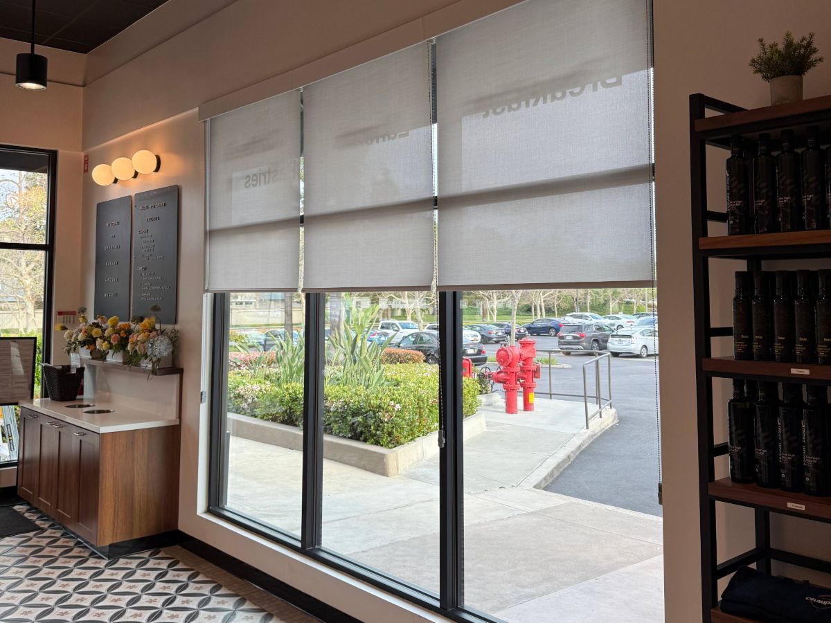 A room with a lot of windows and a fire hydrant in the background.