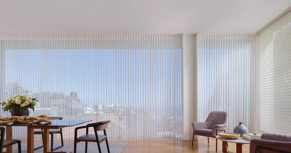 a living room entertainment center with a flat screen tv on the wall .