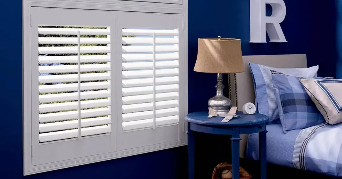 a child's room featuring a play area, toys, and blinds on the window